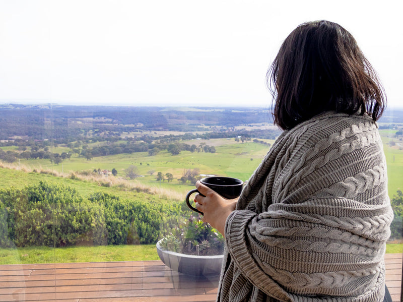 Organic cotton throw in grey wearing by woman