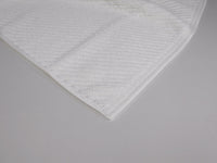 Organic cotton bath mat close up in white
